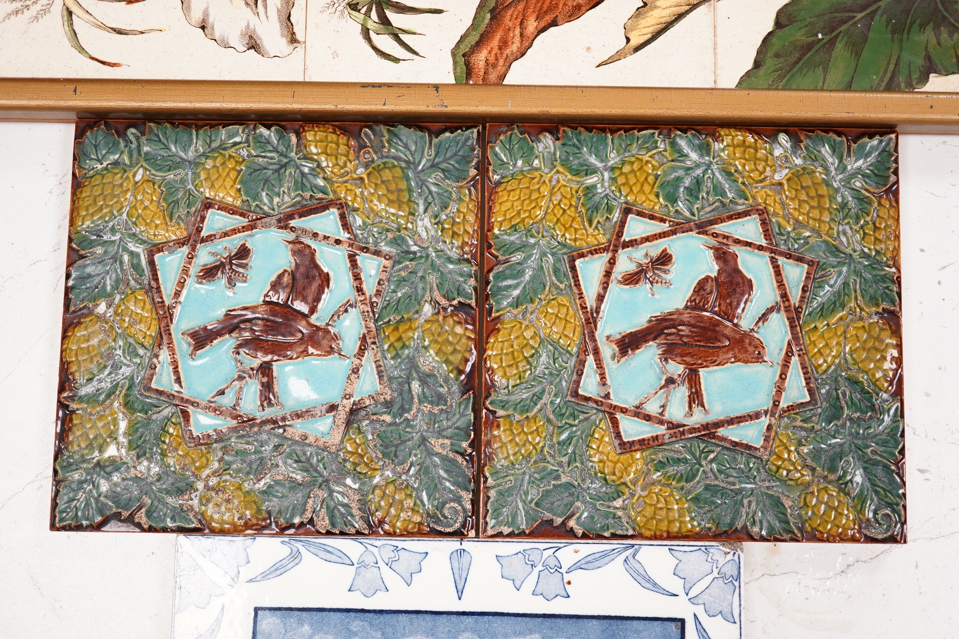 A Victorian five tile framed panel, a Wedgwood November tile and two majolica tiles, five tile panel 80cm high. Condition - worn and crazed